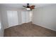 Bright bedroom with ceiling fan, wood-look floors, and ample closet space at 5893 Welcome Rd # I-7, Bradenton, FL 34207