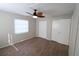 Bright bedroom with ceiling fan, wood-look floors, and ample closet space at 5893 Welcome Rd # I-7, Bradenton, FL 34207