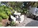 Charming tiled patio table and benches with lush landscaping at 5893 Welcome Rd # I-7, Bradenton, FL 34207