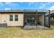 View of a house's back and screened patio with a grassy backyard at 5914 Fiore Dr, Bradenton, FL 34208