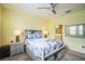 Serene bedroom with ceiling fan, window shutters and en-suite bathroom at 5914 Fiore Dr, Bradenton, FL 34208