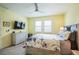 Spacious bedroom with large TV, dresser, and ceiling fan at 5914 Fiore Dr, Bradenton, FL 34208