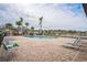 Community pool with plenty of lounge chairs and a view of the neighborhood at 5914 Fiore Dr, Bradenton, FL 34208