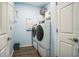 Bright laundry room with washer, dryer, and built-in shelving at 5914 Fiore Dr, Bradenton, FL 34208