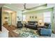 Living room with gray couches, a large TV, and sliding doors to a patio at 5914 Fiore Dr, Bradenton, FL 34208