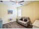 Small sitting room featuring a light yellow wall and gray couch at 5914 Fiore Dr, Bradenton, FL 34208