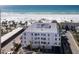 Aerial view of a modern condominium complex near a beach with white sands at 6100 Midnight Pass Rd # 401, Sarasota, FL 34242