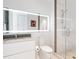 Modern bathroom featuring a large mirror with LED lighting and glass-enclosed shower at 6100 Midnight Pass Rd # 401, Sarasota, FL 34242