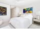 Bright bedroom featuring modern art, and closet doors at 6100 Midnight Pass Rd # 401, Sarasota, FL 34242