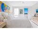 Bright bedroom featuring modern art, and light wood furniture at 6100 Midnight Pass Rd # 401, Sarasota, FL 34242