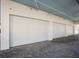 Spacious three car garage with brick pavers and white doors at 6100 Midnight Pass Rd # 401, Sarasota, FL 34242