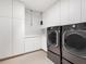 Well-organized laundry room featuring modern washer and dryer units and ample storage at 6100 Midnight Pass Rd # 401, Sarasota, FL 34242