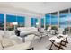 Bright living room with modern decor, furniture and ocean views through expansive windows at 6100 Midnight Pass Rd # 401, Sarasota, FL 34242