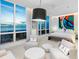 Light-filled main bedroom with ocean views, modern furniture and vibrant artwork at 6100 Midnight Pass Rd # 401, Sarasota, FL 34242