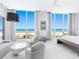 Bright main bedroom with ocean views, seating area, and minimalist decor at 6100 Midnight Pass Rd # 401, Sarasota, FL 34242