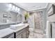 Modern bathroom with a walk-in shower and updated fixtures at 6140 Midnight Pass Rd # 902, Sarasota, FL 34242