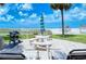 Beachfront patio with grill and seating at 6140 Midnight Pass Rd # 902, Sarasota, FL 34242