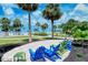 Ocean view patio with colorful chairs and green space at 6140 Midnight Pass Rd # 902, Sarasota, FL 34242