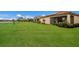 Large backyard with green grass and a view of the canal at 6527 Clairborne Ln, Bradenton, FL 34211