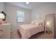 Charming bedroom with pink bedding and full-length mirror at 6527 Clairborne Ln, Bradenton, FL 34211