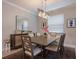 Formal dining room with a large table, six chairs, and a modern chandelier at 6527 Clairborne Ln, Bradenton, FL 34211