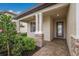 Covered front porch entry with stone columns and paver flooring at 6527 Clairborne Ln, Bradenton, FL 34211