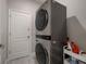 Laundry room with stackable washer and dryer and a convenient storage cart at 6527 Clairborne Ln, Bradenton, FL 34211