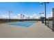 Well-lit outdoor tennis court with new surfacing at 6527 Clairborne Ln, Bradenton, FL 34211