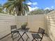 Private patio with modern furniture and tall fence for added privacy at 6946 Woodwind Dr # 2, Sarasota, FL 34231