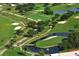 Aerial view of lush green golf course and lake at 6947 Lennox Pl, University Park, FL 34201