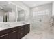 Spa-like bathroom with double vanity and glass shower at 6947 Lennox Pl, University Park, FL 34201