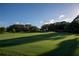 Picturesque golf course putting green with flag and tree shadows at 6947 Lennox Pl, University Park, FL 34201