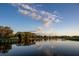 Serene lake view with a wooden bridge and lush greenery at 6947 Lennox Pl, University Park, FL 34201