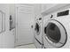 Laundry room with washer, dryer and extra storage at 6947 Lennox Pl, University Park, FL 34201