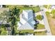 Aerial view of a single-Gathering home with a metal roof and large backyard at 7820 Holiday Dr, Sarasota, FL 34231