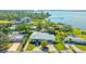 Aerial view of a single-Gathering home with a metal roof and driveway at 7820 Holiday Dr, Sarasota, FL 34231