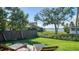 Landscaped backyard with lush lawn and view of the water at 7820 Holiday Dr, Sarasota, FL 34231