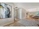 Open and airy entryway with hardwood floors and large artwork at 7820 Holiday Dr, Sarasota, FL 34231