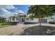 Beautiful waterfront home with a metal roof, landscaping, and a 2-car garage at 7820 Holiday Dr, Sarasota, FL 34231