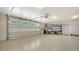 Spacious garage with epoxy flooring, overhead storage, and shelving at 7820 Holiday Dr, Sarasota, FL 34231