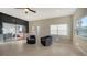 Bright sitting room with sliding doors to patio, hardwood floors, and a modern feel at 7820 Holiday Dr, Sarasota, FL 34231