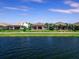 Houses along a calm lake on a sunny day at 7917 Mainsail Ln, Sarasota, FL 34240