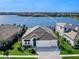 An aerial view of a single-Gathering home with a lake in the background at 7917 Mainsail Ln, Sarasota, FL 34240