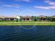 Houses along a calm lake on a sunny day at 7917 Mainsail Ln, Sarasota, FL 34240