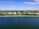 Houses along a calm lake on a sunny day at 7917 Mainsail Ln, Sarasota, FL 34240