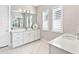 Modern bathroom with white vanity, quartz countertop and plantation shutters at 7917 Mainsail Ln, Sarasota, FL 34240