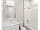 Guest bathroom with white vanity, bathtub, and marble tile at 7917 Mainsail Ln, Sarasota, FL 34240