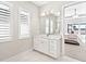 Clean bathroom with white vanity, quartz countertop and marble floor at 7917 Mainsail Ln, Sarasota, FL 34240