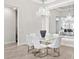 Elegant dining room with crystal chandelier and glass top table at 7917 Mainsail Ln, Sarasota, FL 34240