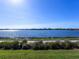 Peaceful lakefront view with grassy areas and walking path at 7917 Mainsail Ln, Sarasota, FL 34240